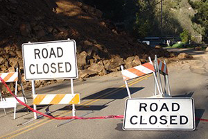 Road signs showing a road is closed due to a landslide